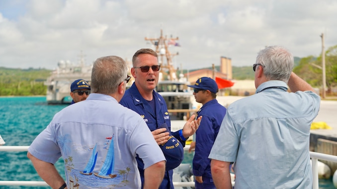 Capt. Nicholas Simmons, commander of U.S. Coast Guard Forces Micronesia/Sector Guam, discusses operations with Congressman Sam Graves, Chairman of the House Committee on Transportation and Infrastructure, and Congressman Mike Bost, Chairman of the House Committee on Veterans Affairs, at the unit in Guam, on April 26, 2024. The delegation spent the afternoon with crews, gaining firsthand insights into the critical operations of the Fast Response Cutters (FRCs) in the region and also toured essential sites of infrastructure, including the damaged glass breakwater and the Port Authority of Guam, from the cutter and the cutter small boat. (U.S. Coast Guard photo by Chief Warrant Officer Sara Muir)