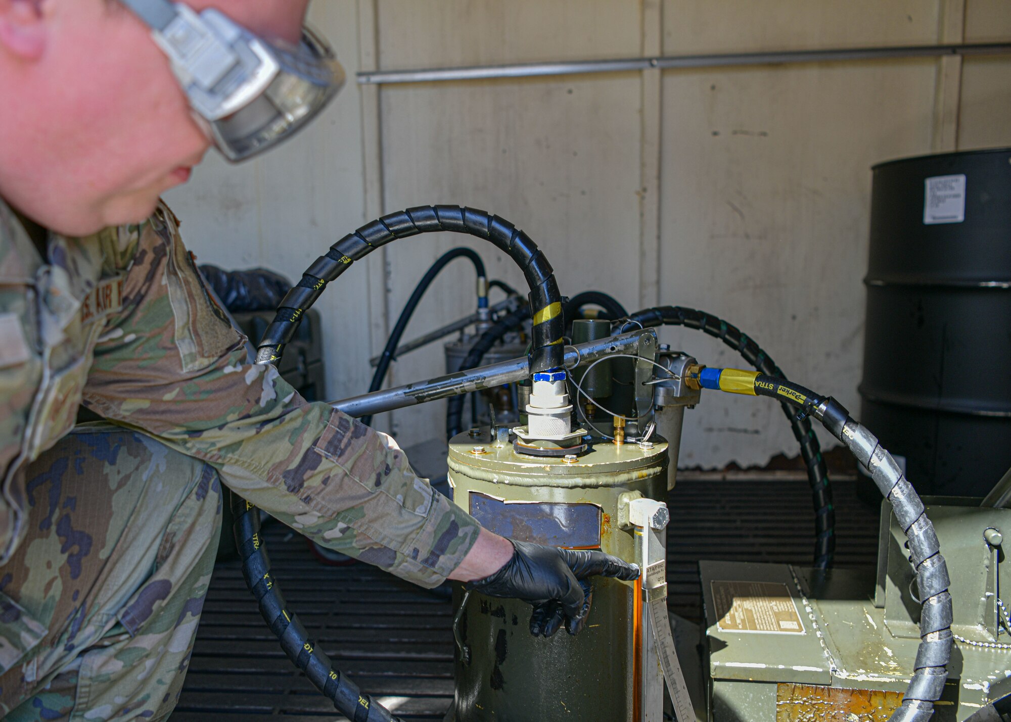 Staff Sgt. Pavel Chumak, 104th Maintenance Group aircraft eletrical and environmental technician, inspects an oil sight guage April 23rd, 2024, at Barnes Air National Guard Base, Massachusetts. Chumak recently received the inspector general coin during the Wing's Capstone inspection after detecting hazardous materials in an oil cart used to service airplanes.