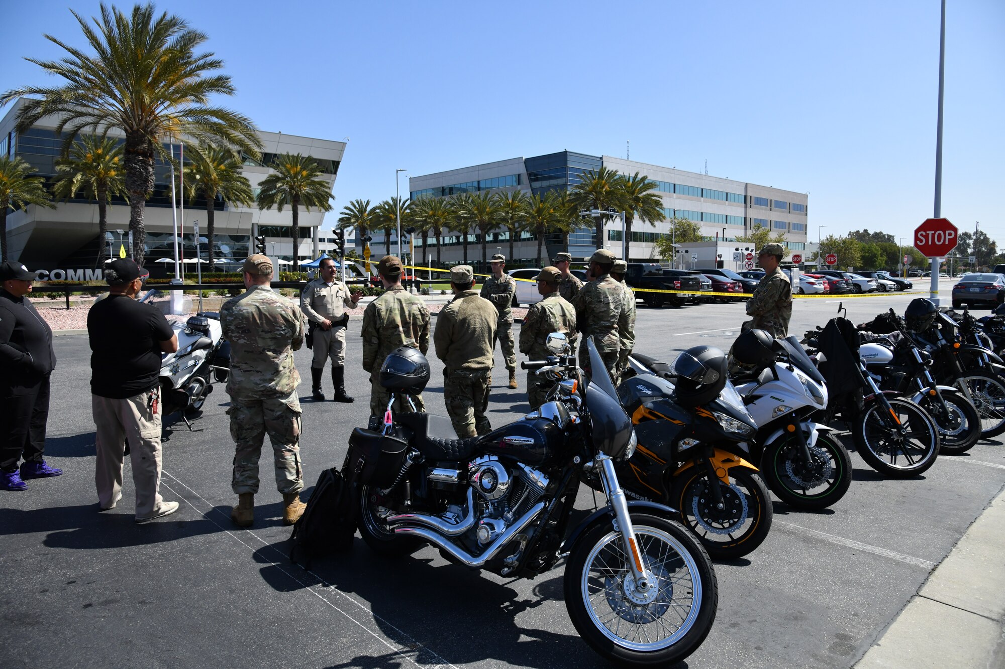 An line of motorcycles is depicted making a perfect back drop during the opening remarks for Motorcycle Safety Awareness Day in the Commissary Parking lot.