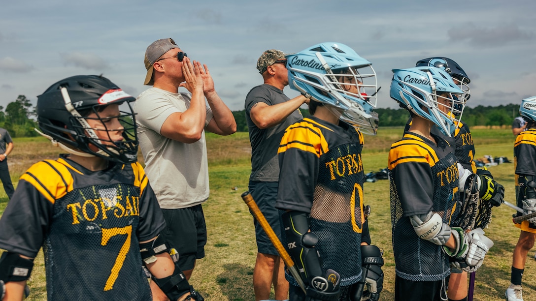 U.S. Marines with 2d Marine Division coach youth lacrosse players in Topsail, North Carolina, April 20, 2024. Volunteering with sports teams helps Marines engage with and contribute to the local communities by mentoring it’s youth. (U.S. Marine Corps photo by Cpl. Max Arellano)