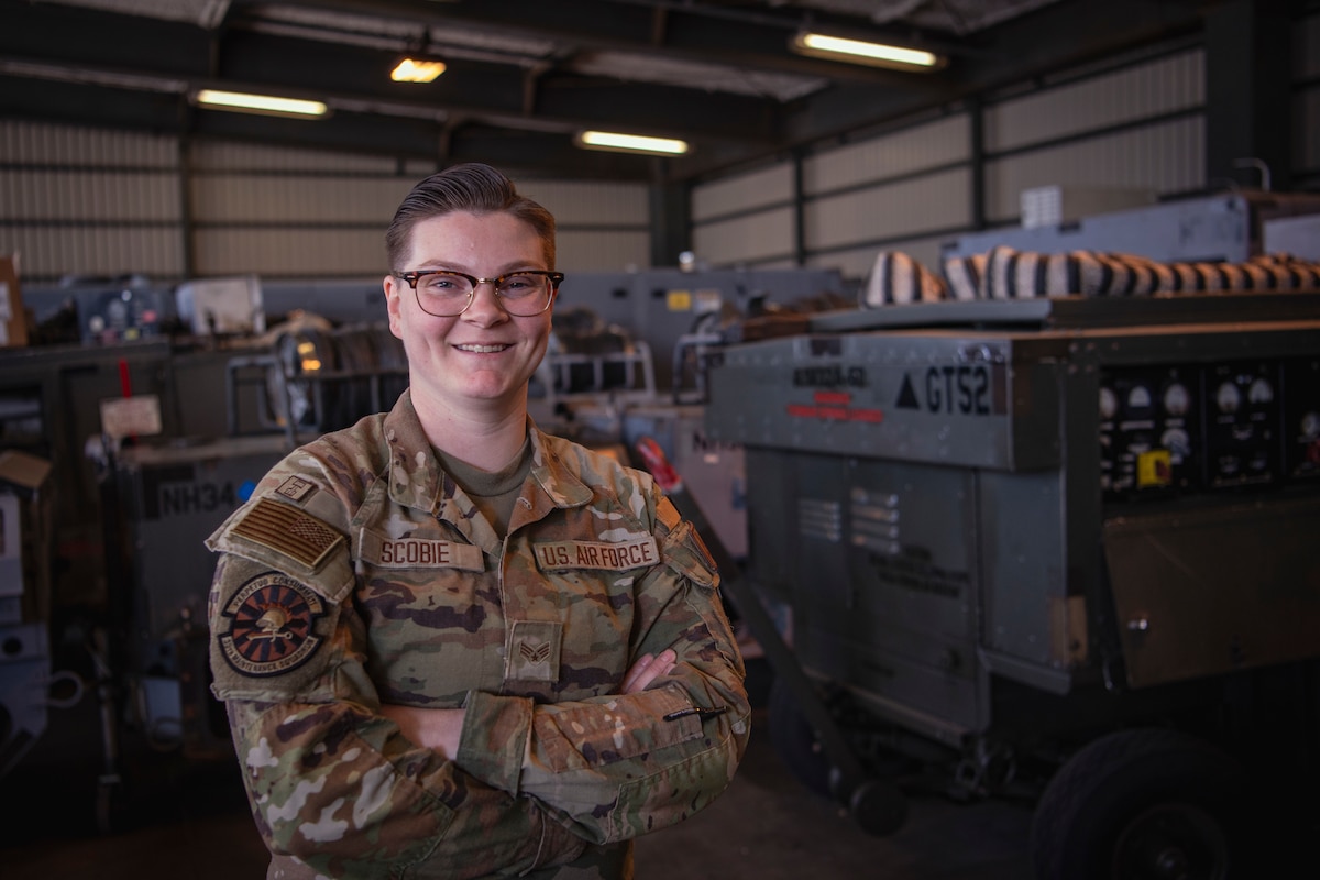 Senior Airman Jennifer Scobie, 35th Maintenance Squadron Aerospace Group Equipment journeyman, poses in front of aircraft maintenance equipment April 22, 2024, at Misawa Air Base, Japan.