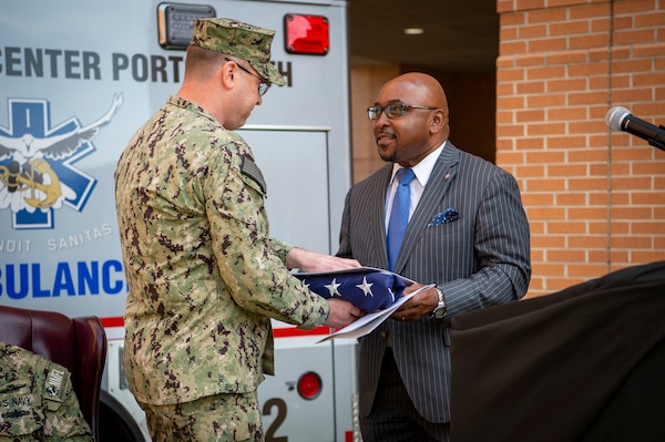 Naval Medical Center Portsmouth (NMCP) hosted the 25th Anniversary celebration of the Charette Health Care Center, or Building 2, April 30. Honorable Shannon E. Glover, City of Portsmouth mayor, was called to the podium to receive a flag that flew in front of the center.  Glover is a former Navy Hospital Corpsman who served from 1988 to 1994, and his last duty station was NMCP.