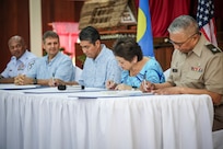 From left, Senior Enlisted Advisor Tony Whitehead, senior enlisted advisor to the chief of U.S. National Guard Bureau; U.S. Ambassador Joel Ehrendreich; Palau President Surangel Whipps; Guam Gov. Lou Leon Guerrero; and Col. Michael Cruz, adjutant general of the Guam National Guard, formalize a State Partnership Program partnership between Guam and Palau in Koror, Palau, April 29, 2024. The partnership builds on thousands of years of common ancestry between the Second Island Chain islands and seeks to mutually benefit both partners in defense and security cooperation.