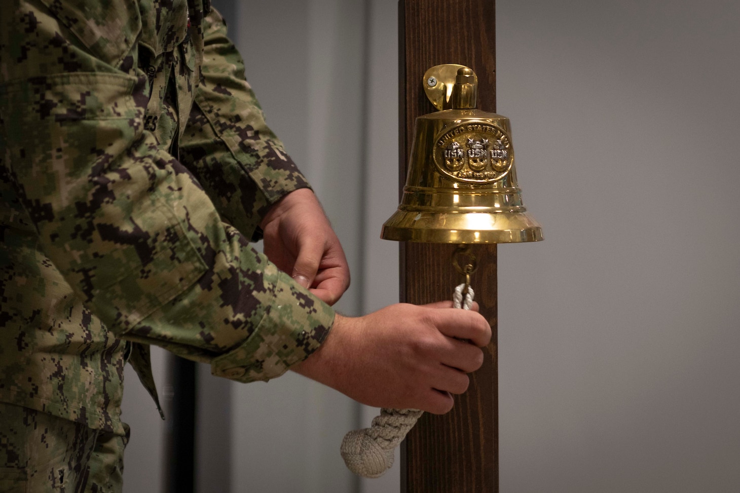 Utilitiesman 3rd Class Christopher Shapard, assigned to Naval Facilities Engineering Systems Command Europe Africa Central, rings a ceremonial bell during a memorial service for Naval Mobile Construction Battalion (NMCB) 14 in The Anchor on May 2, 2024.