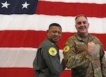 Royal Thai Air Force Group Capt. Sithipol Pomtri, left, deputy director, office of operations and training, and Brig. Gen. Gent Welsh, Washington Air National Guard commander, exchange Enduring Partners 24 exercise uniform patches on Camp Murray, Wash., April 30, 2024. EP24 is an exercise between the Washington Air National Guard and the Royal Thai Air Force.