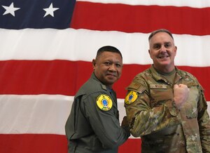 Royal Thai Air Force Group Capt. Sithipol Pomtri, left, deputy director, office of operations and training, and Brig. Gen. Gent Welsh, Washington Air National Guard commander, exchange Enduring Partners 24 exercise uniform patches on Camp Murray, Wash., April 30, 2024. EP24 is an exercise between the Washington Air National Guard and the Royal Thai Air Force.