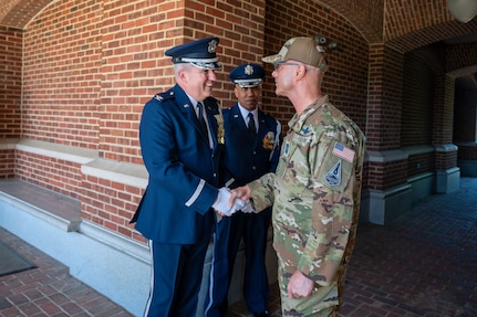 Chief Master Sergeant of the U.S. Space Force John F. Bentivegna (right) engages U.S. Air Force Chaplain (Col.) William Spenser (left) and U.S. Air Force Col. Ron Armstrong (center) from the Arlington National Cemetery Chaplain Corps