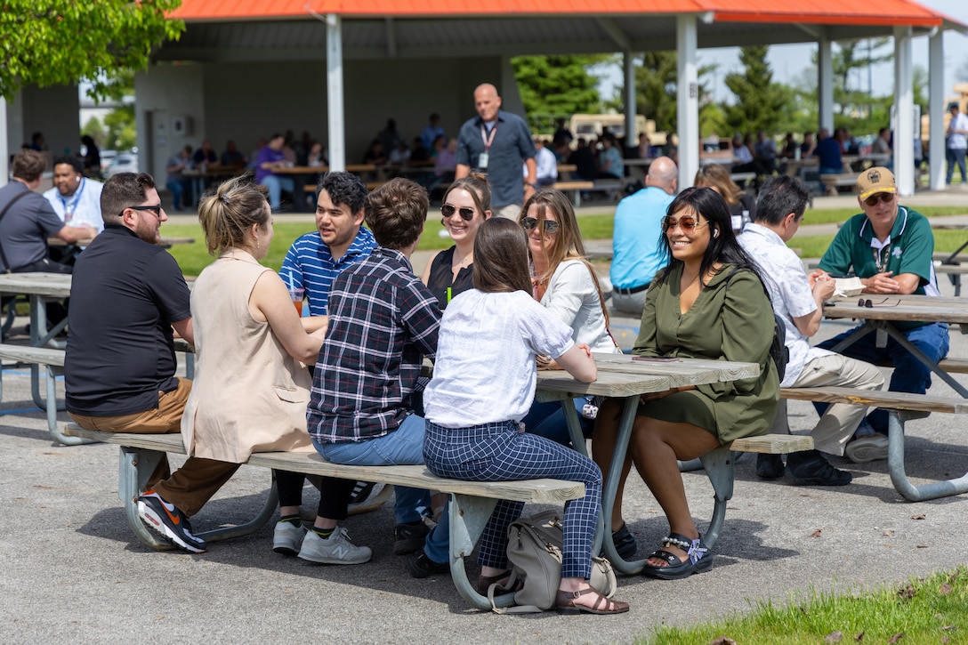People sit at picnic table outside