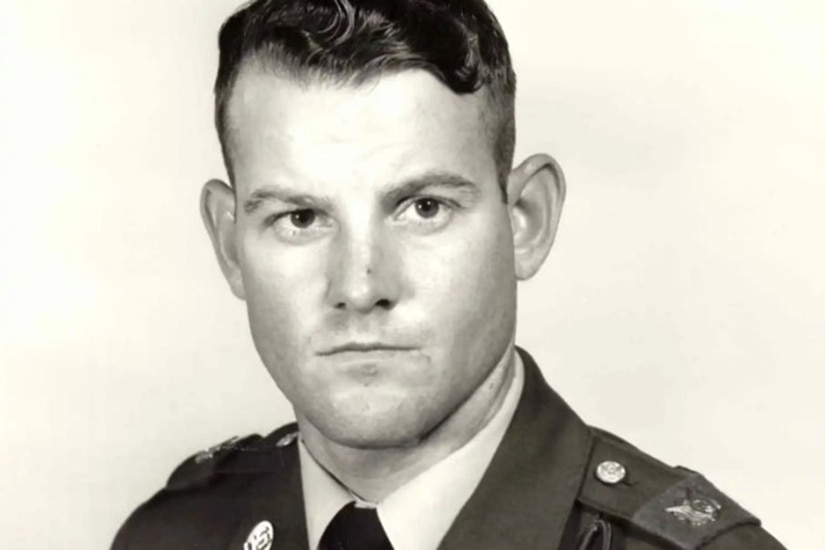 A person in uniform poses for a black and white photo.