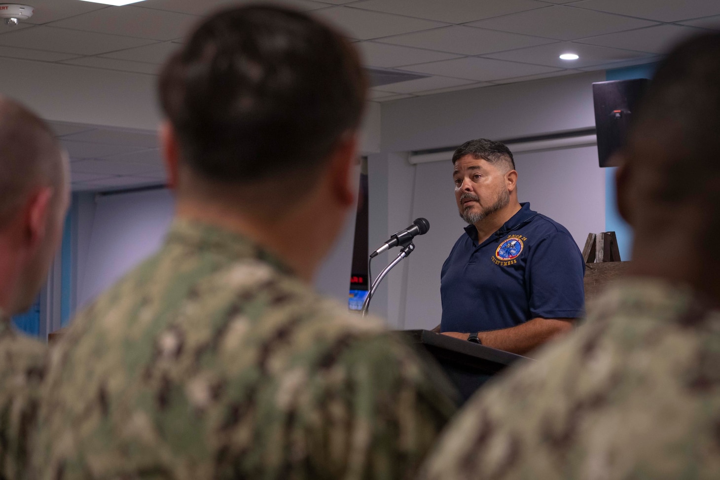 Retired Senior Chief Construction Mechanic, Francisco Landrau, assigned to Naval Support Activity Souda Bay, talks about his personal experience serving with Naval Mobile Construction Battalion (NMCB) 14 during a memorial service for NMCB-14 in The Anchor on May 2, 2024.