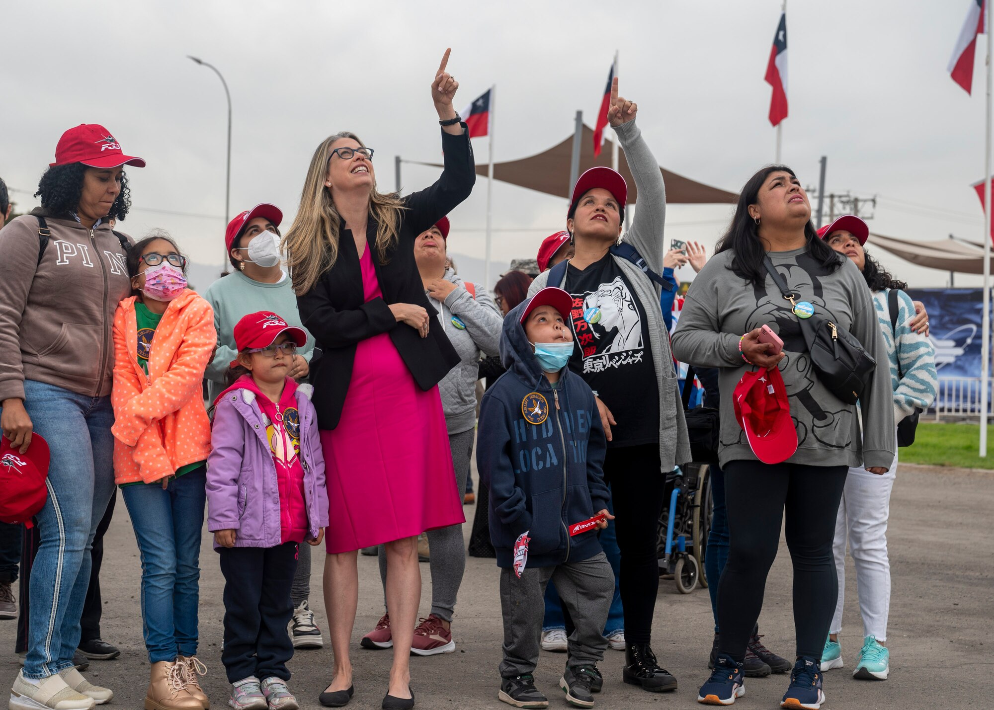 U.S. Ambassador to Chile Bernadette Meehan and families from the Teleton Foundation look to the skies during the Internacional del Aire y del Espacio (FIDAE), an international air and space show, at Pudahuel Air Base, Chile, April 12, 2024.