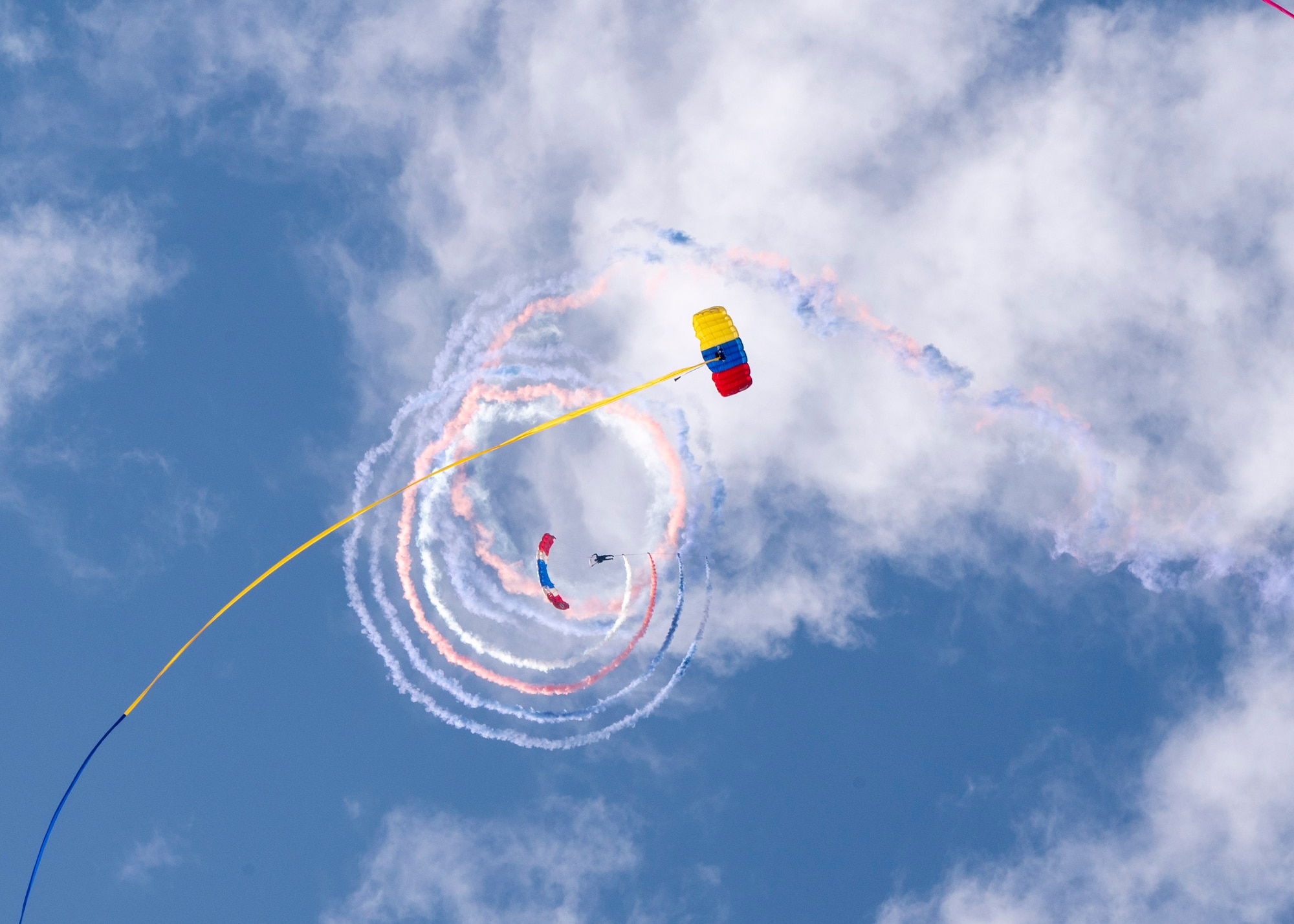 A member of the Colombian air force’s Aguila de Gules Parachuting Team and a member of the Chilean air force’s Boinas Azules (Blue Berets) Parachute Squadron descend during the Feria Internacional del Aire y del Espacio (FIDAE), an international air and space show, at Pudahuel Air Base, Chile, April 13, 2024.
