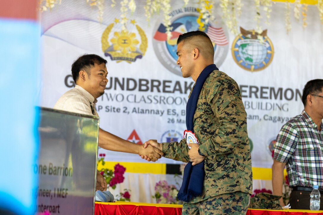U.S. Marine Corps Lt. Col. Tyrone Barrion, and a force engineer with I Marine Expeditionary Force, greets Honorable Danta Agatep, the Municipal Mayor of Lasam, during a groundbreaking ceremony at Alannay Elementary School prior to the commencement of Exercise Balikatan 24 in Cagayan, Philippines, March 26, 2024.