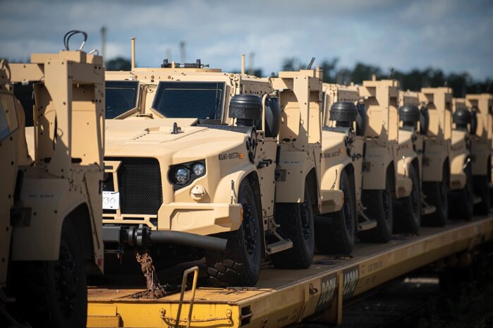 210812-N-GB257-002 Charleston, S.C. (August 12, 2021) Railcars holding nearly 200 Joint Light Tactical Vehicles (JLTVs) await integration at Naval Information Warfare Center (NIWC) Atlantic headquarters in Charleston, South Carolina. The command integrated its 1,000th JLTV on Aug. 13, a short eight months after the specialized work was fully consolidated in one location. (U.S. Navy photo by Joe Bullinger/Released)