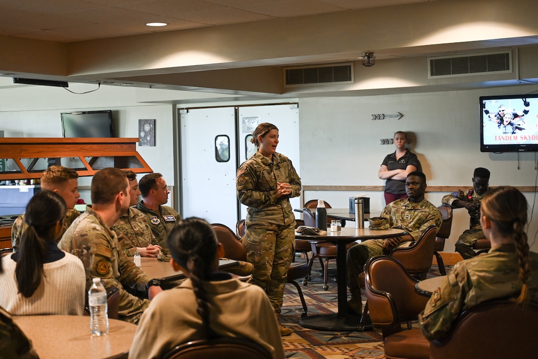 U.S. Air Force Capt. Mira Hoppe, 97th Operations Support Squadron Intelligence Flight commander, greeted ROTC cadets at Altus Air Force Base, Oklahoma, April 25, 2024. Hoppe and other 97th Air Mobility Wing leaders informed the cadets about Air Force life and careers. (U.S. Air Force photo by Airman Lauren Torres)