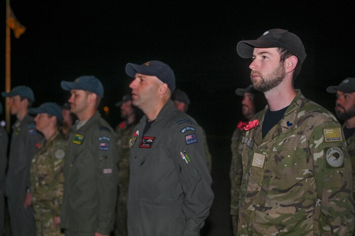 Members of the Royal New Zealand Air Force stand at attention for New Zealand national anthem during Anzac Day at Little Rock Air Force Base, Ark., April 25, 2024.