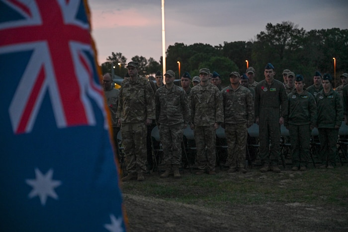 Members of Team Little Rock stand at attention for ‘The Last Post’ during Anzac Day at Little Rock Air Force Base, Ark., April 25, 2024.