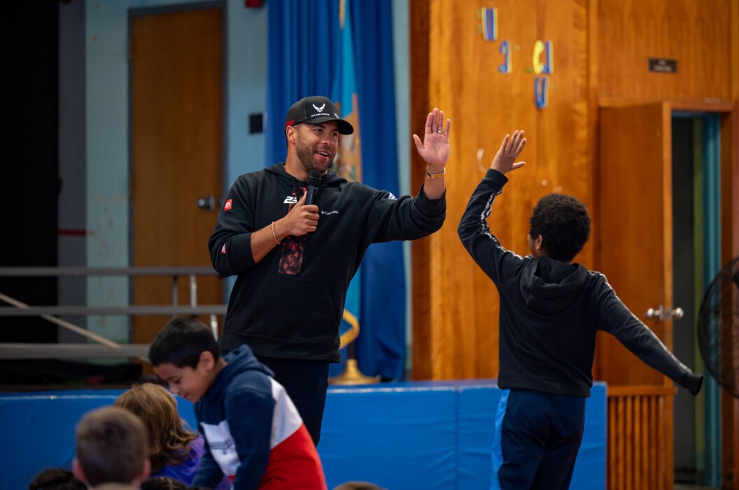 Bubba Wallace, Würth 400 NASCAR Cup Series driver, gives a high-five to a student during his speech at Maj. George S. Welch Elementary School on Dover Air Force Base, Delaware, April 26, 2024. Wallace spoke with students during his visit to Dover AFB before the weekend’s race at Dover Motor Speedway. (U.S. Air Force photo by Airman 1st Class Amanda Jett)