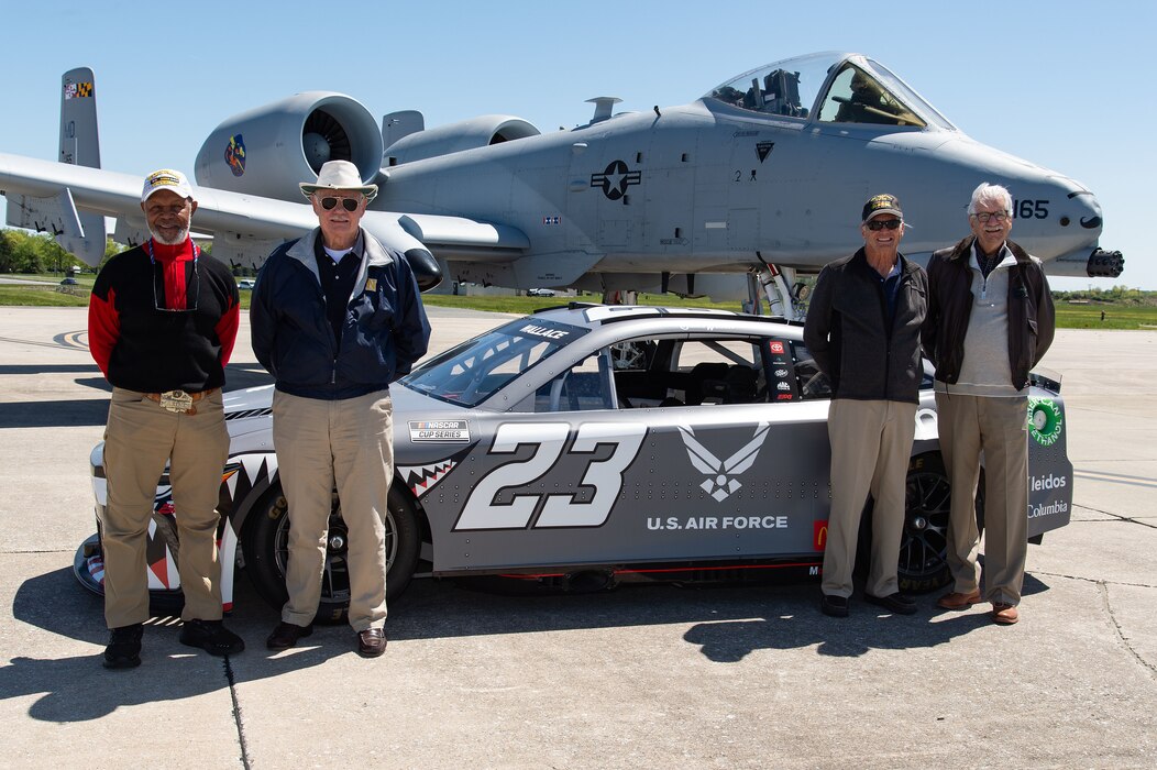 John Gillett, Elester Latham, James Lloy, and William Moir pose with the Würth 400 NASCAR Cup No. 23 Toyota Camry and two U.S. Air Force A-10C Thunderbolt IIs at Dover Air Force Base, Delaware, April 26, 2024. The race car is adorned with their names. (U.S. Air Force photo by Roland Balik)