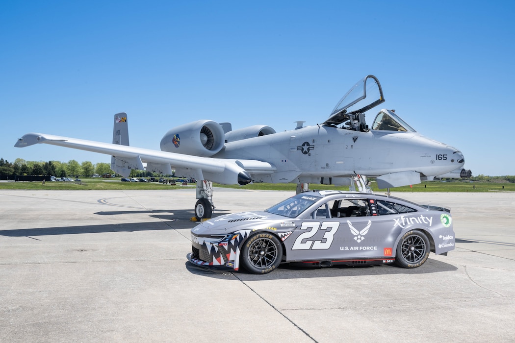 The Würth 400 NASCAR Cup Series No. 23 Toyota Camry sits with a U.S. Air Force A-10C Thunderbolt II on the flight line at Dover Air Force Base, Delaware, April 26, 2024. Bubba Wallace, the car’s driver, toured Dover AFB before the weekend’s race at Dover Motor Speedway. (U.S. Air Force photo by Mauricio Campino)