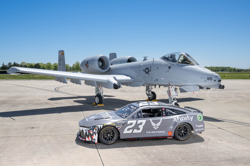 The Würth 400 NASCAR Cup Series No. 23 Toyota Camry sits with a U.S. Air Force A-10C Thunderbolt II on the flight line at Dover Air Force Base, Delaware, April 26, 2024. Bubba Wallace, the car’s driver, toured Dover AFB before the weekend’s race at Dover Motor Speedway. (U.S. Air Force photo by Mauricio Campino)
