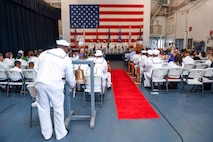 Attendees watch a ceremony.