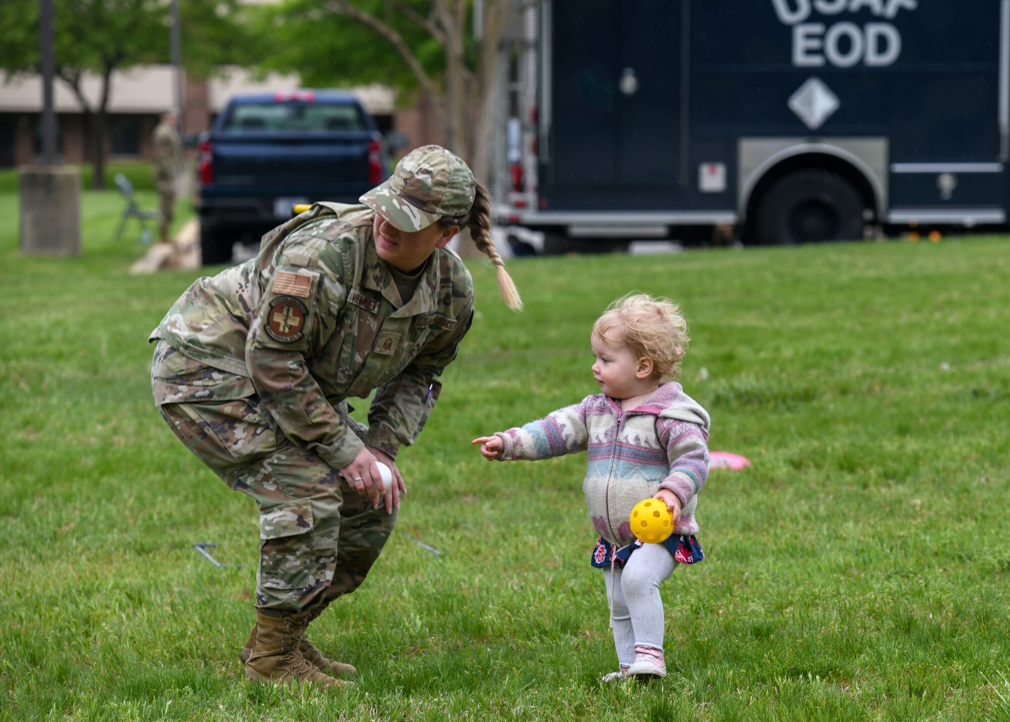 Woman and girl play catch.