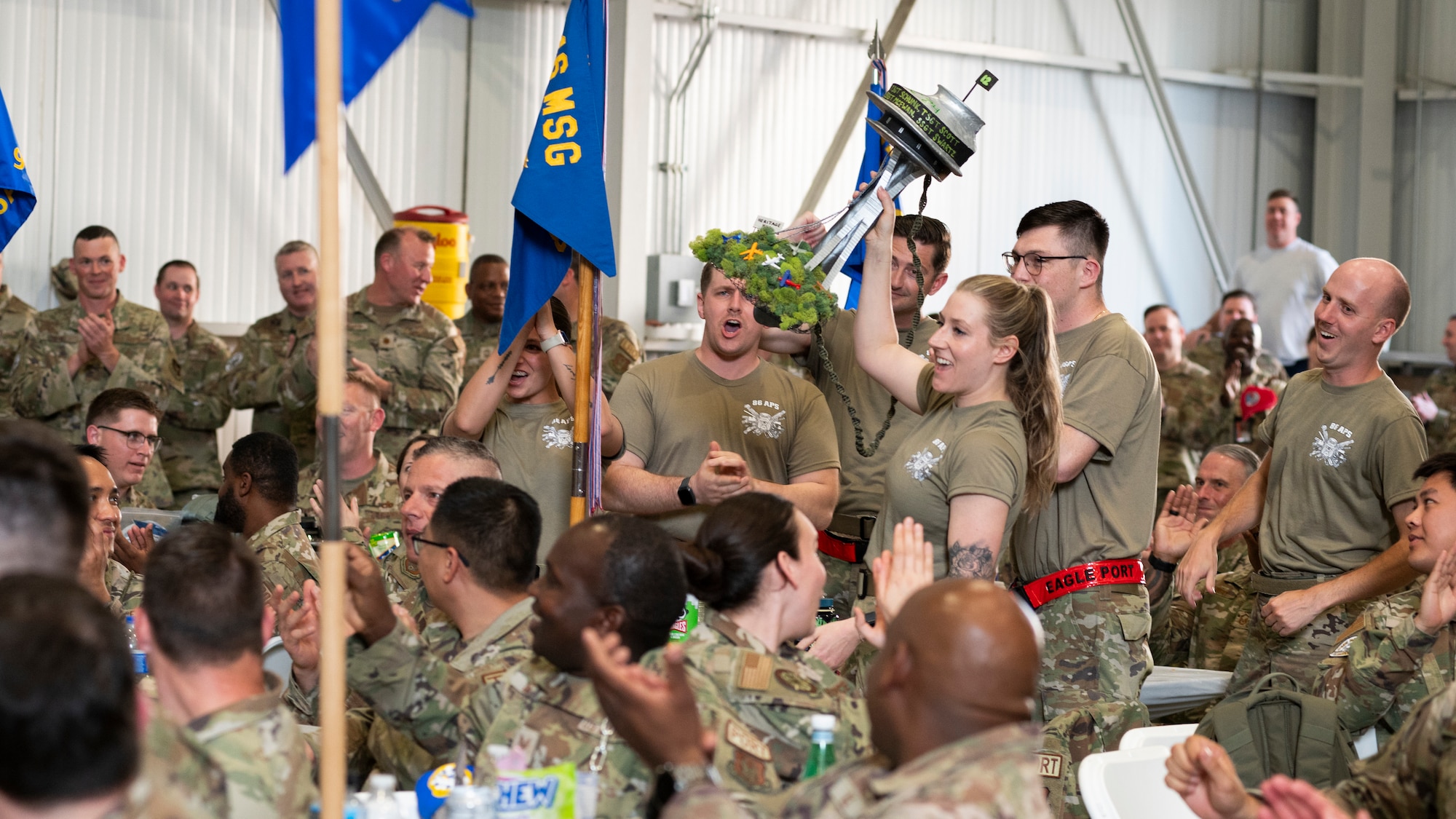people in military uniforms cheer