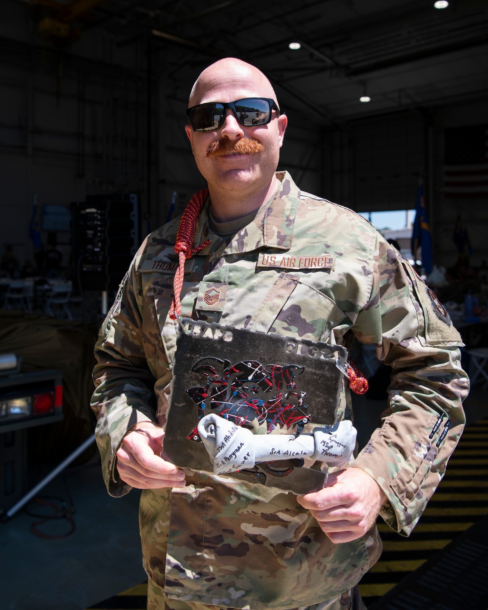 a person in a military uniform wearing a bone-shaped award around his neck