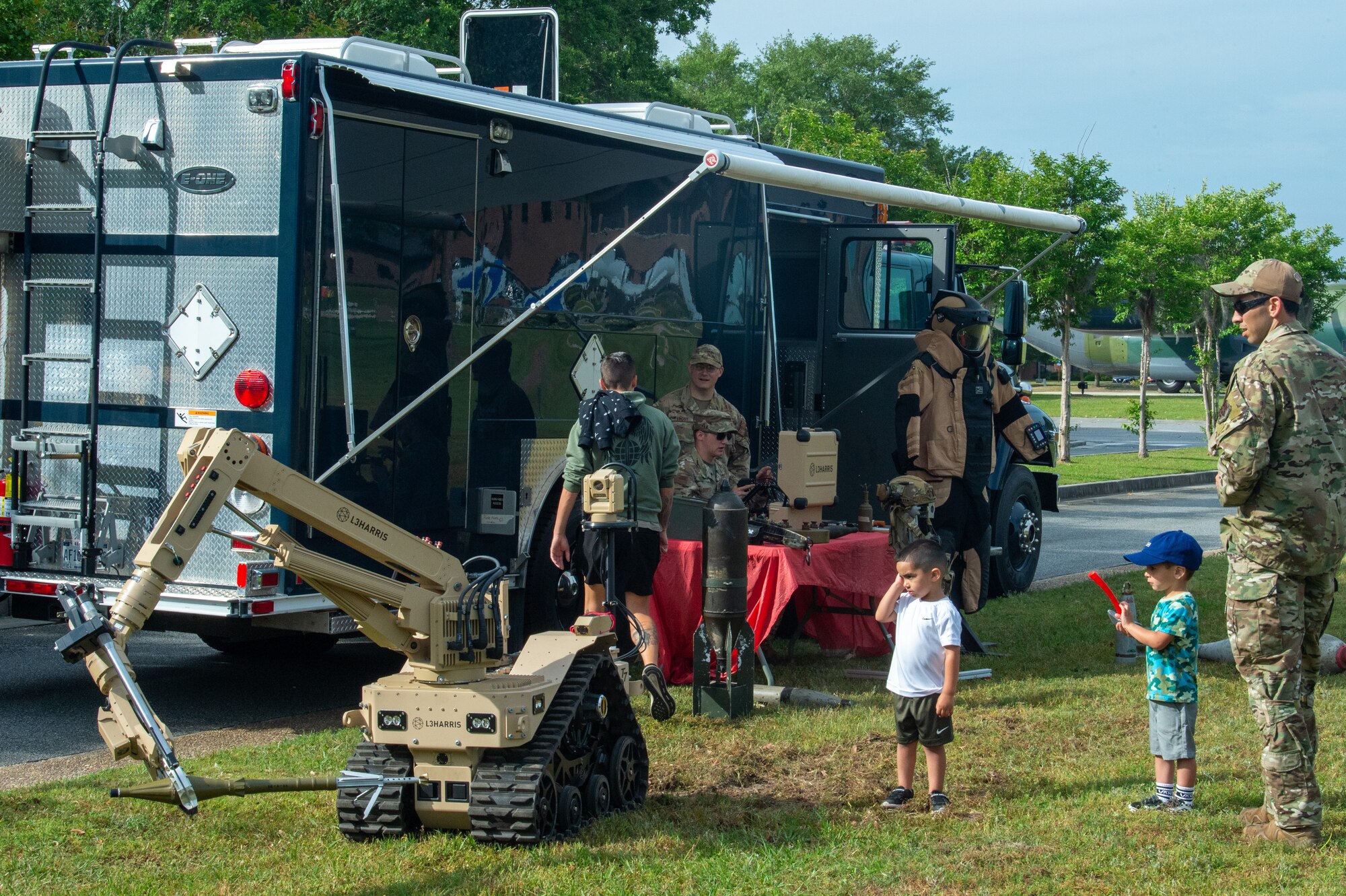 Military families standing around a career booth