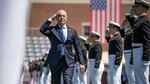Secretary of Homeland Security Alejandro Mayorkas salutes during commencement exercises at the Coast Guard Academy.