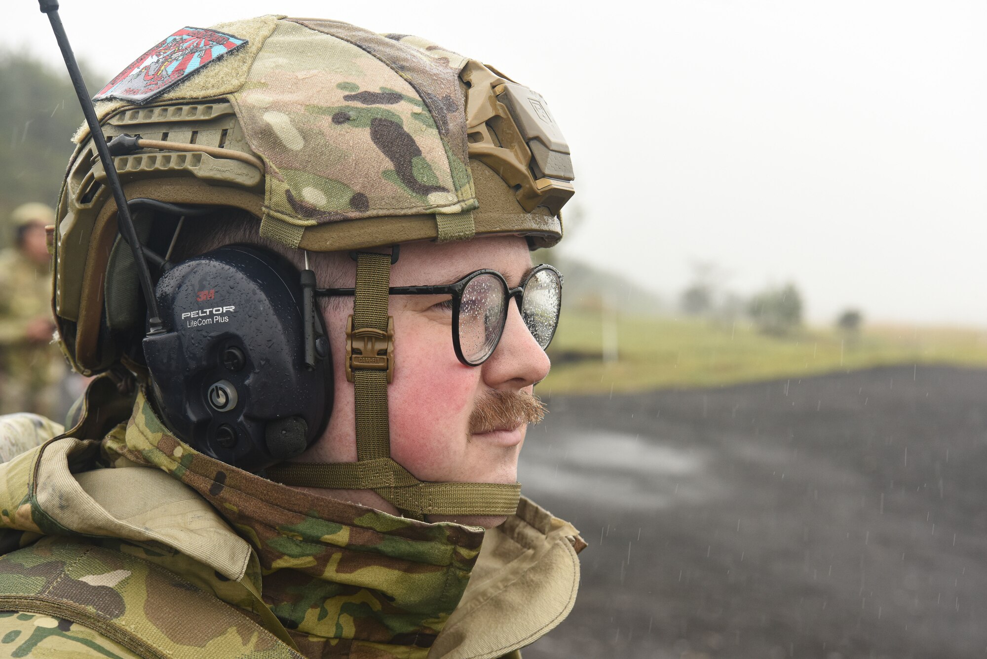 A U.S. servicemember gazes out towards the firing range.