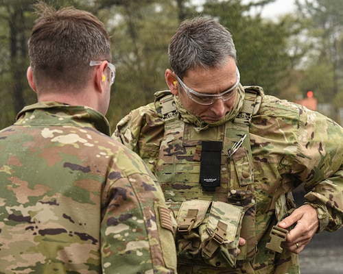 A U.S. military member puts on safety equipment.