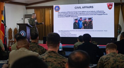 Lt. Col. Chris Bridger, 1st Civil Affairs Group Combined Joint Civil-Military Task Force deputy commander, gives a brief on Marine Corps Civil Affairs during a Civil-Military Operations subject matter expert exchange as part of Exercise Balikatan 24 at Camp Aguinaldo, Manila,  Philippines, April 29, 2024. Armed Forces of the Philippines and U.S. CMO specialists shared the best civil affairs practices and their experiences when military forces were called to support civilian populations during the COVID-19 pandemic, natural disasters, and refugee crises. BK 24 is an annual exercise between the Armed Forces of the Philippines and the U.S. military designed to strengthen bilateral interoperability, capabilities, trust, and cooperation built over decades of shared experiences. (U.S. Air Force photo by Staff Sgt. Pedro Tenorio)