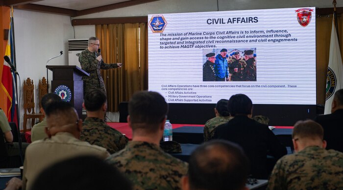Lt. Col. Chris Bridger, 1st Civil Affairs Group Combined Joint Civil-Military Task Force deputy commander, gives a brief on Marine Corps Civil Affairs during a Civil-Military Operations subject matter expert exchange as part of Exercise Balikatan 24 at Camp Aguinaldo, Manila,  Philippines, April 29, 2024. Armed Forces of the Philippines and U.S. CMO specialists shared the best civil affairs practices and their experiences when military forces were called to support civilian populations during the COVID-19 pandemic, natural disasters, and refugee crises. BK 24 is an annual exercise between the Armed Forces of the Philippines and the U.S. military designed to strengthen bilateral interoperability, capabilities, trust, and cooperation built over decades of shared experiences. (U.S. Air Force photo by Staff Sgt. Pedro Tenorio)