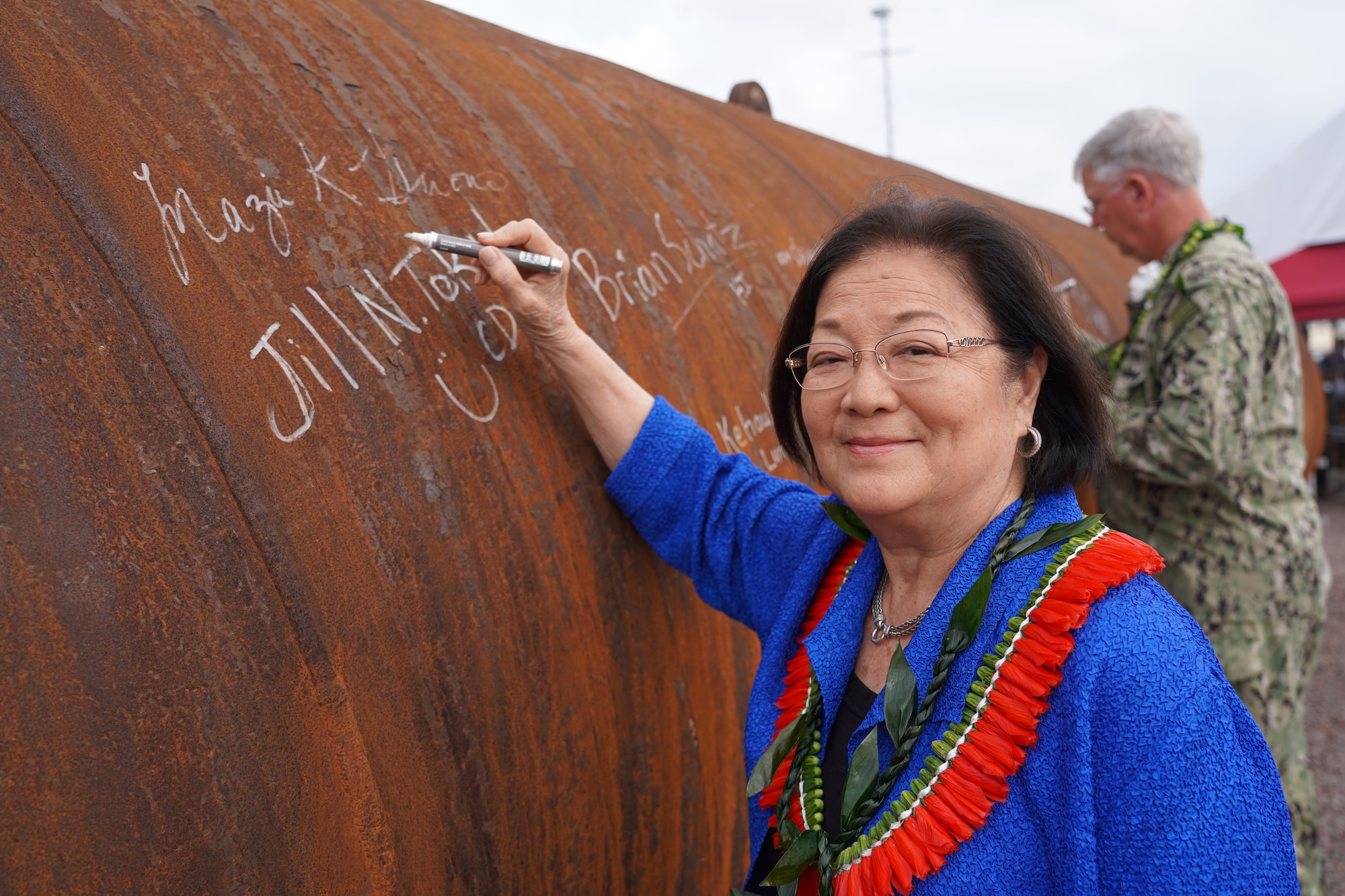 Hawaii Sen. Mazie Hirono adds her name to history at the Pearl Harbor Naval Shipyard & Intermediate Maintenance Facility (PHNSY & IMF) Dry Dock 5 Anchoring Ceremony as she signs a pile that will become part of the first new dry dock to be built at PHNSY & IMF since 1943.