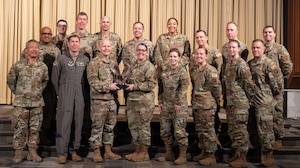 U.S. Air Force Col. Daniel Hoadley, 5th Bomb Wing Commander, congratulates Team Minot Chaplain Corps on winning the Air Force Global Strike Command Charles I. Carpenter Outstanding Large Chaplain Corps Team Award at Minot Air Force Base, North Dakota, May 1, 2024. The team award selections are determined based on the following Chaplain Corps Lines of Effort: Fortify Warfighter Readiness, Reimage Chaplain Culture and Rebuild Chaplain Readiness. (U.S. Air Force photo by Airman 1st Class Trust Tate)