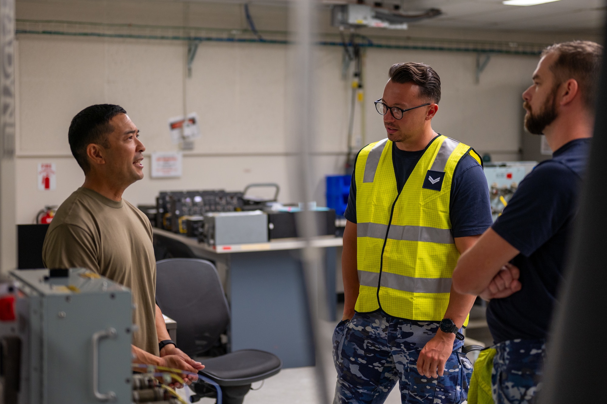 Airmen talks to Royal Australian Air Force members about aircraft avionics.