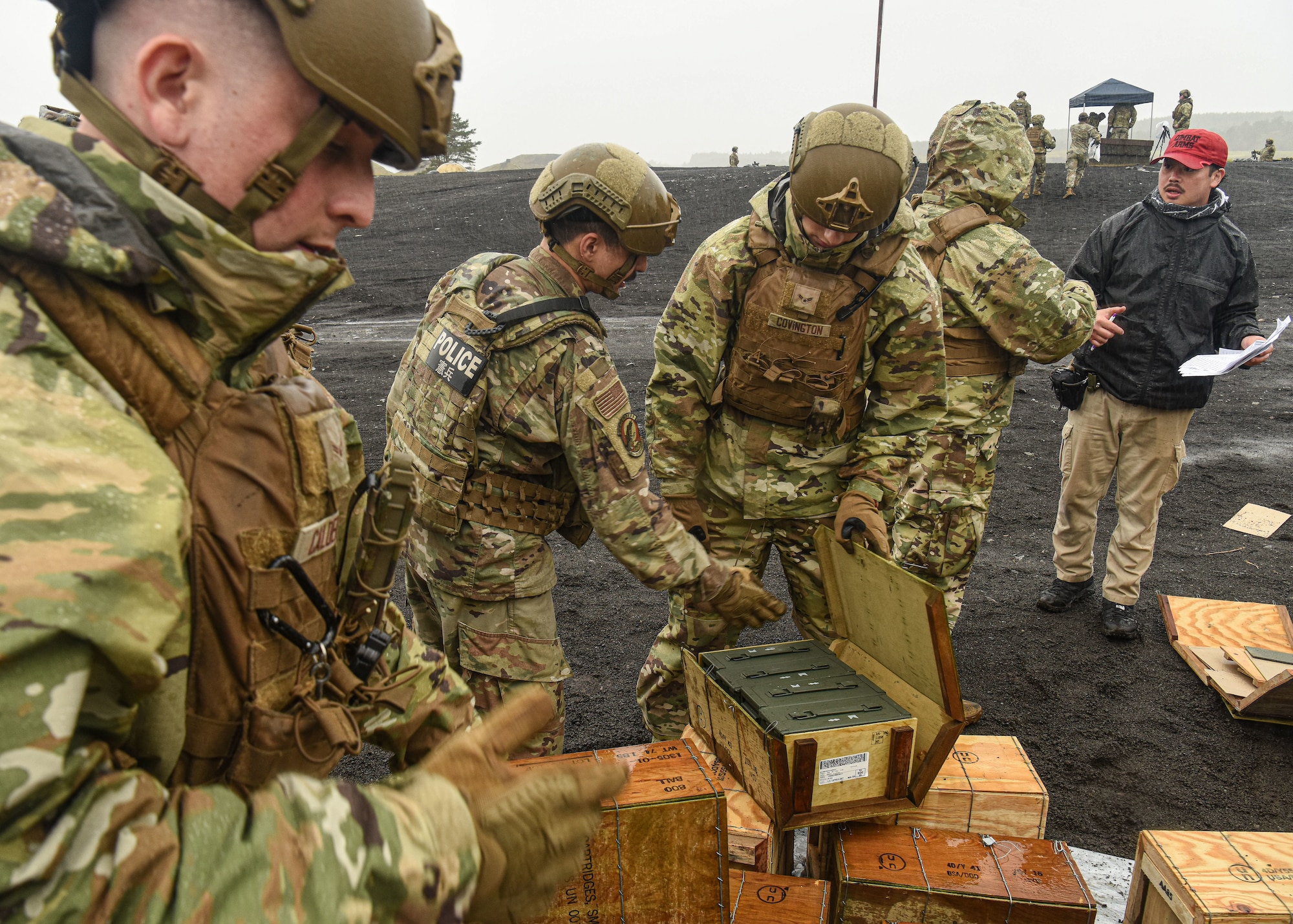 U.S. servicemembers open up boxes of ammunition.