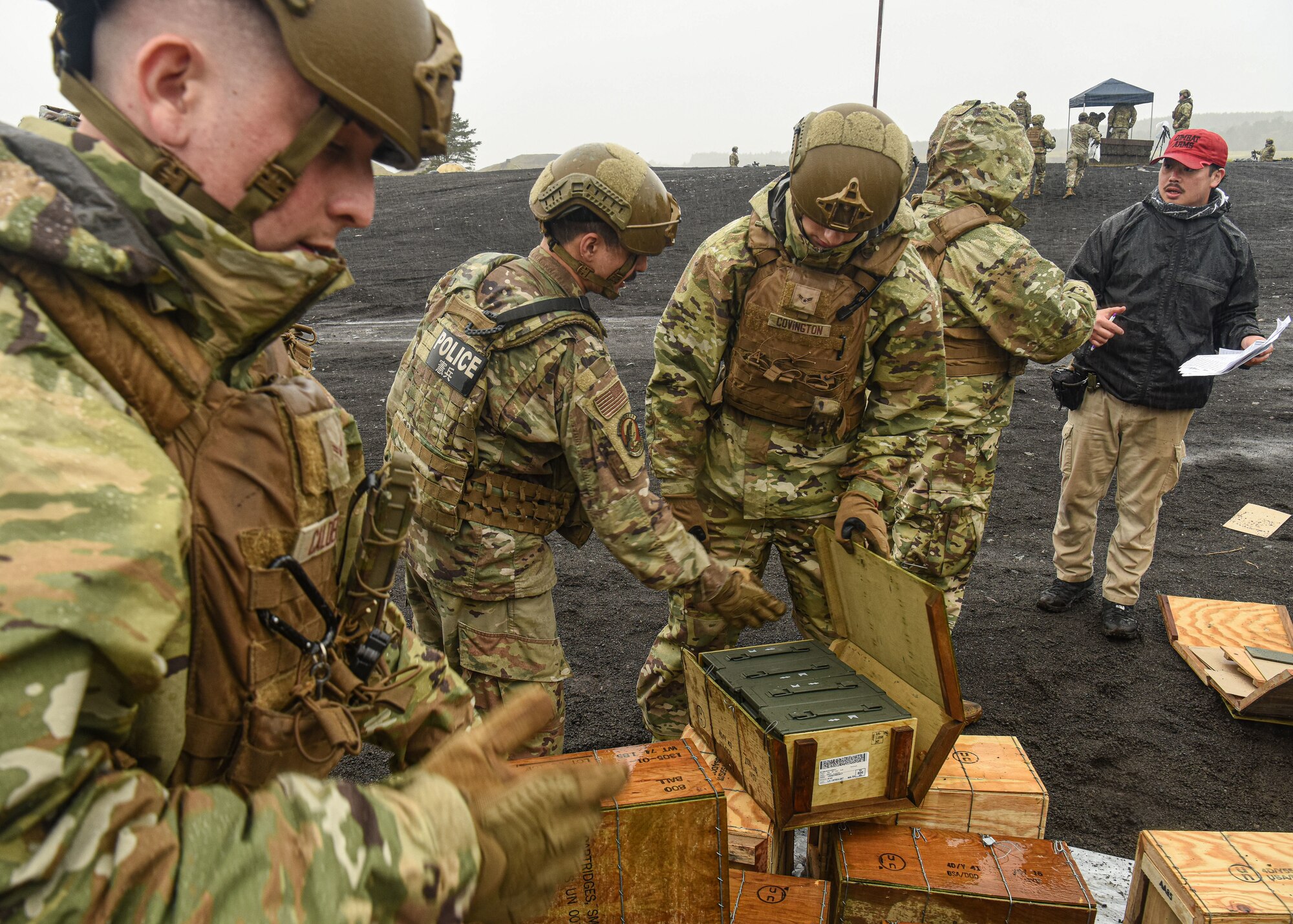 U.S. servicemembers open up boxes of ammunition.