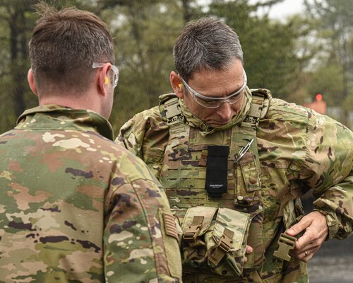 A U.S. military member puts on safety equipment.