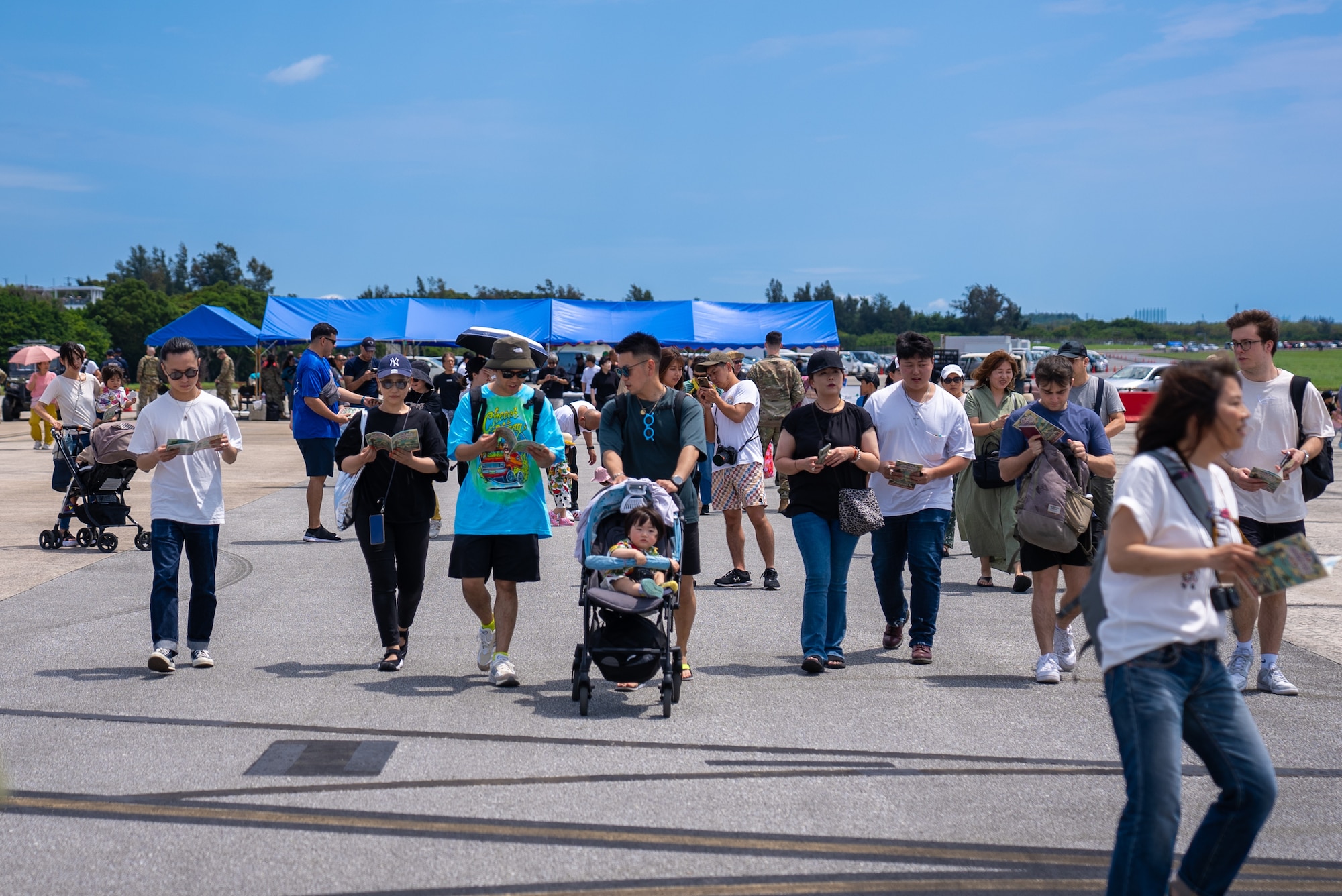 Festival attendees make their way onto the flightline for America Fest at Kadena Air Base, Japan, April 27, 2024.