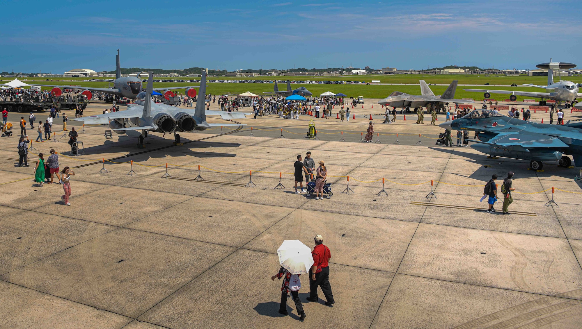 America Fest attendees walk the flight line to view multiple aircraft on display at Kadena Air Base, Japan, April 27, 2024.