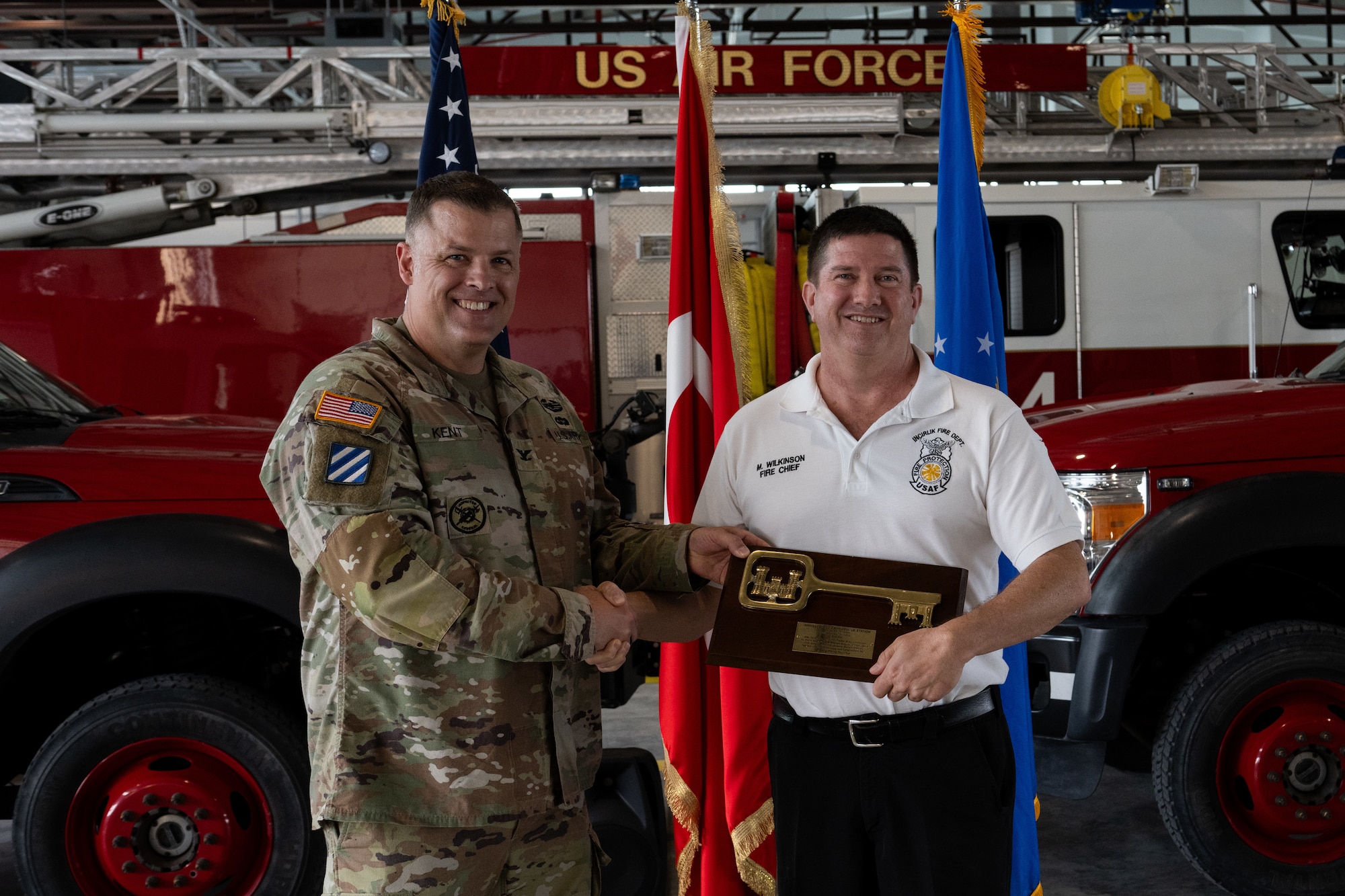 U.S. Army Col. Dan Kent, U.S. Army Corps of Engineers Europe District commander, and Michael Wilkinson, 39th Air Base Wing fire chief, pose for a photo holding a plaque.