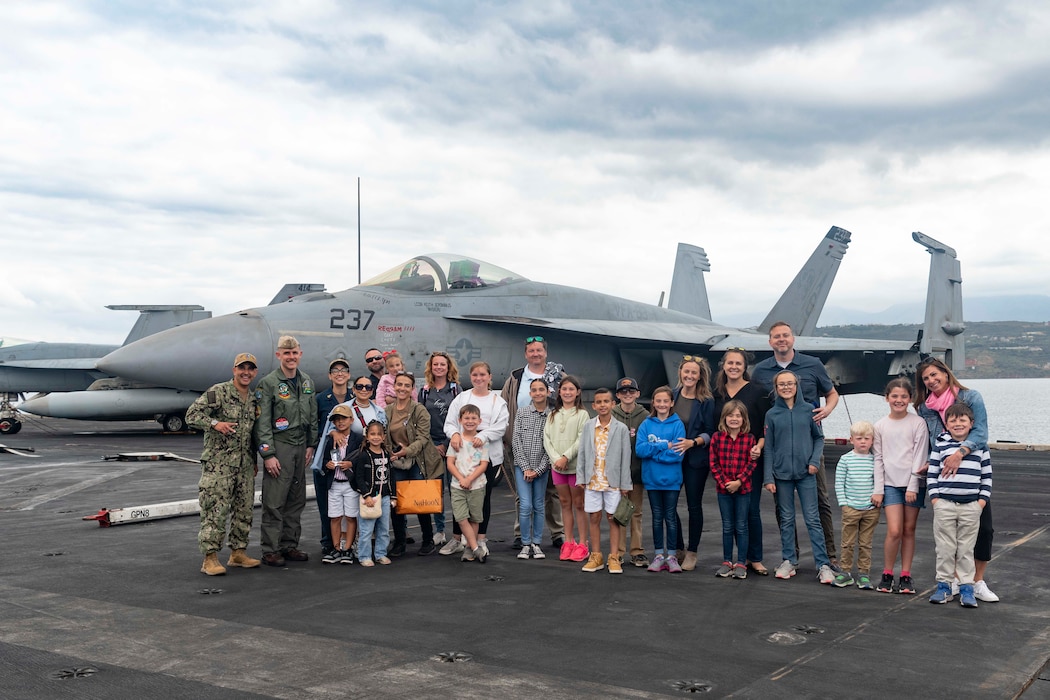 Personnel and families assigned to Naval Support Activity Souda Bay are welcomed aboard the Nimitz-class aircraft carrier USS Dwight D. Eisenhower (CVN 69) for a tour of the ship in honor of the Month of the Military Child at the NATO Marathi Pier Complex on April 30, 2024.