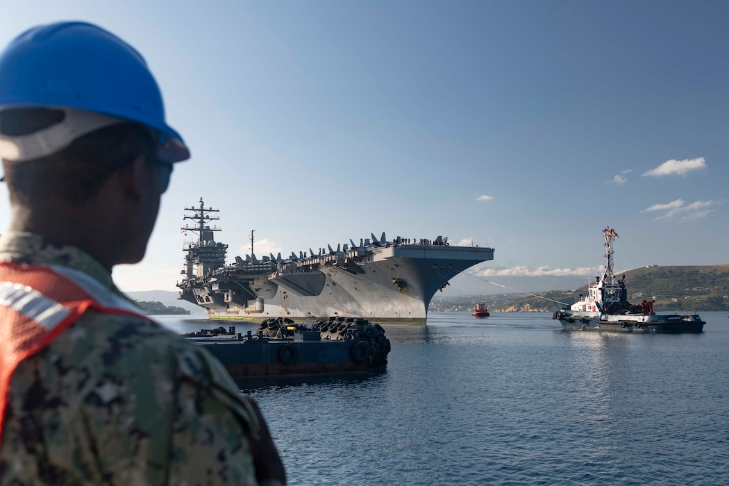 Construction Electrician 3rd Class Sean Lassiter, assigned to Naval Facilities Engineering Systems Command, Europe, Africa, Central, watches as the Nimitz-class aircraft carrier USS Dwight D. Eisenhower (CVN 69) arrives in Souda Bay, Crete, for a scheduled port visit on April 28, 2024.