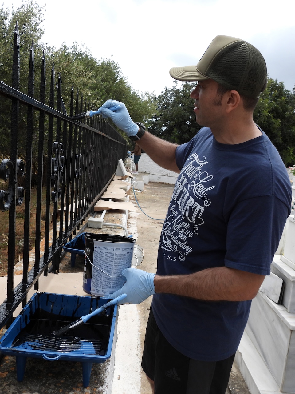Lt. Juan Garcia, assigned to the Nimitz-class aircraft carrier USS Dwight D. Eisenhower (CVN 69), paints a fence during a two-day community relations project at the St. Ioannis Orthodox church in Mouzouras, Chania on April 29-30 as part of their regularly scheduled port visit.