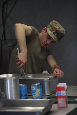 Pfc. Miguel Rodriguez, a culinary specialist with 903rd Quartermaster Field Feeding Platoon, 90th Troop Command, prepares food during the inaugural OKARNG Culinary Excellence Challenge at Camp Gruber Training Center, April 27, 2024. The OKARNG hosted its inaugural state-level culinary competition to bring Soldiers together to demonstrate their proficiency in a variety of culinary tasks and drills, fostering a culture of esprit de corps, resiliency, and personal growth for OKARNG Culinary Specialists. (Oklahoma National Guard photo by Sgt. Elliott Kim)