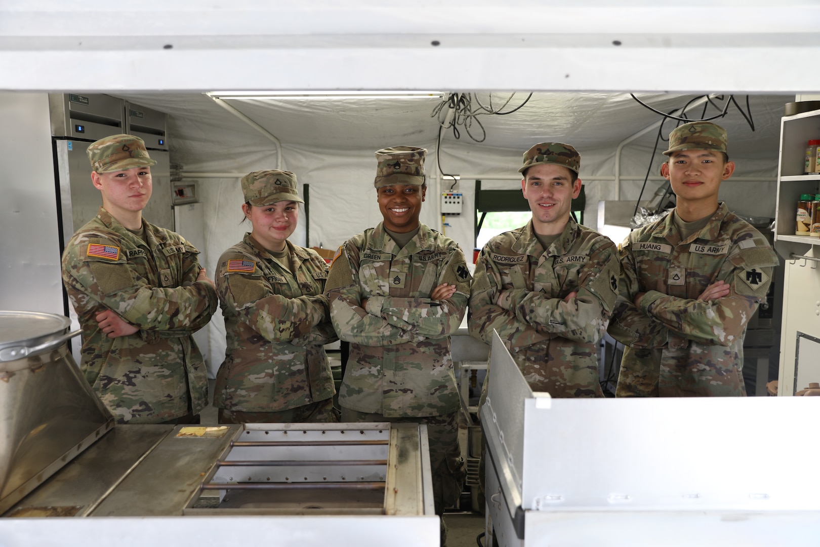 left to right: Pfc. Jeremiah Scrapper, culinary specialist, Pfc. Samantha Coffman, culinary specialist, Staff Sgt. Malikah Green, culinary noncommissioned officer, Pfc. Miguel Rodriguez, culinary specialist, and Pfc. Ziyu Huang, culinary specialist, all members of the 903rd Quartermaster Field Feeding Platoon, stand for a group photo during the inaugural OKARNG Culinary Excellence Challenge at Camp Gruber Training Center, April 27, 2024. The team from the 903rd took first place at the inaugural state-level culinary competition. (Oklahoma National Guard photo by Sgt. Elliott Kim)