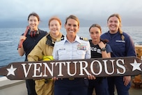 The women of the U.S. Coast Guard Cutter Venturous (WMEC 625) pose for a photo at sea in the Caribbean on March 15, 2024, in honor of Women's History Month. Pictured from left to right: Ensign Claire Portigue, Lt. j.g Josephine St. Ledger, Cmdr. Karen L. Kutkiewicz (Center), Lt. j.g Kristin Heinkel, Ensign Molly McVay. ( U.S. Coast Guard photo by Petty Officer 2nd Class Kekoa Taijeron)